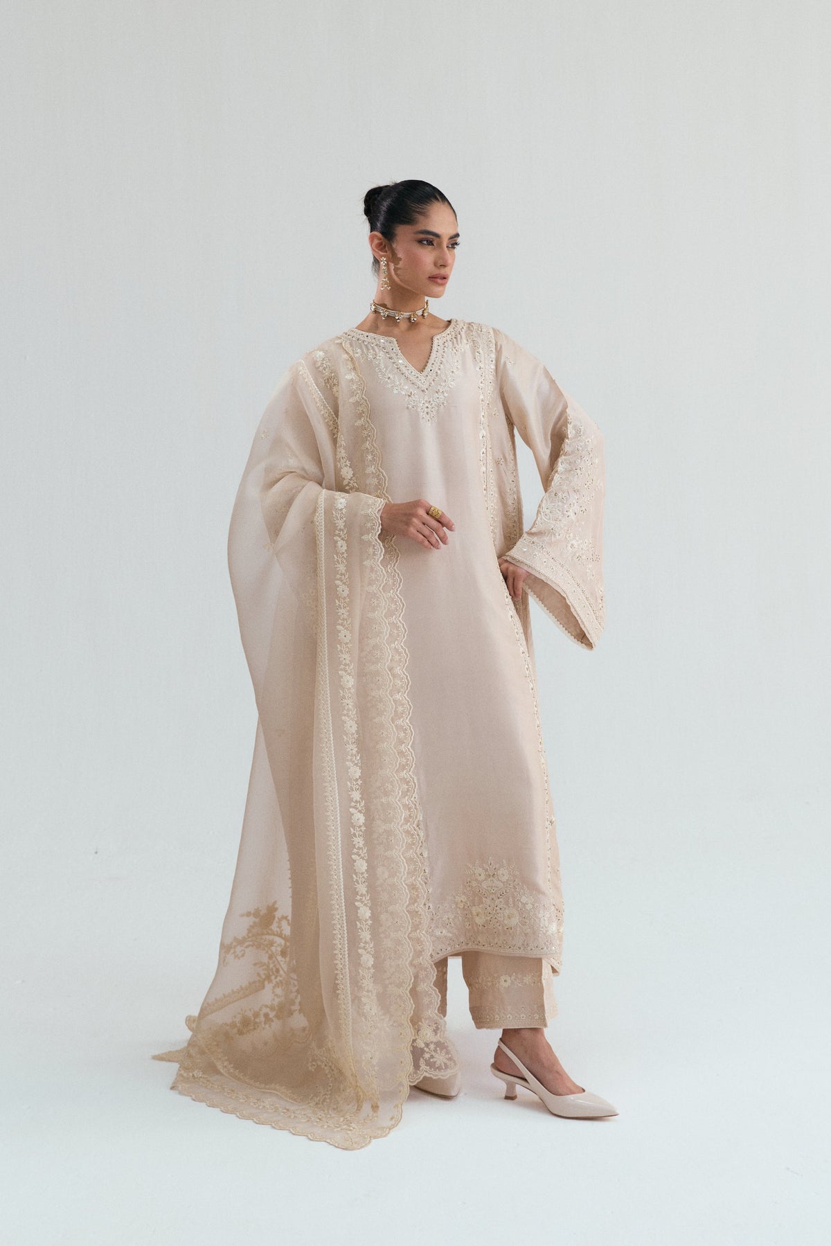 Honey gold silk Pakistani salwar kameez with intricate hand embroidery and mirror embellishments, full front view