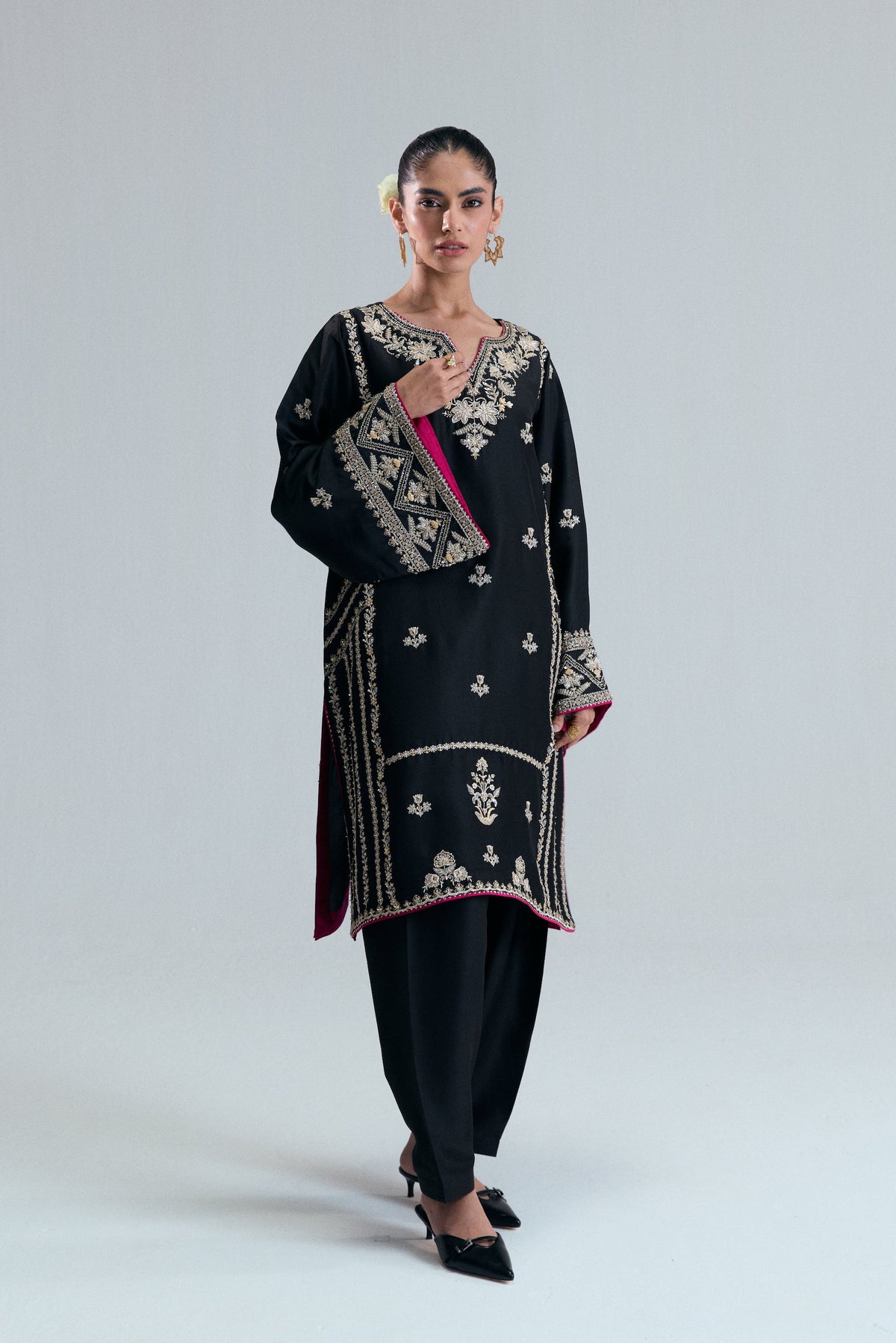 A black silk shirt called the Starlight Set with bright floral sewing and matching black pants.