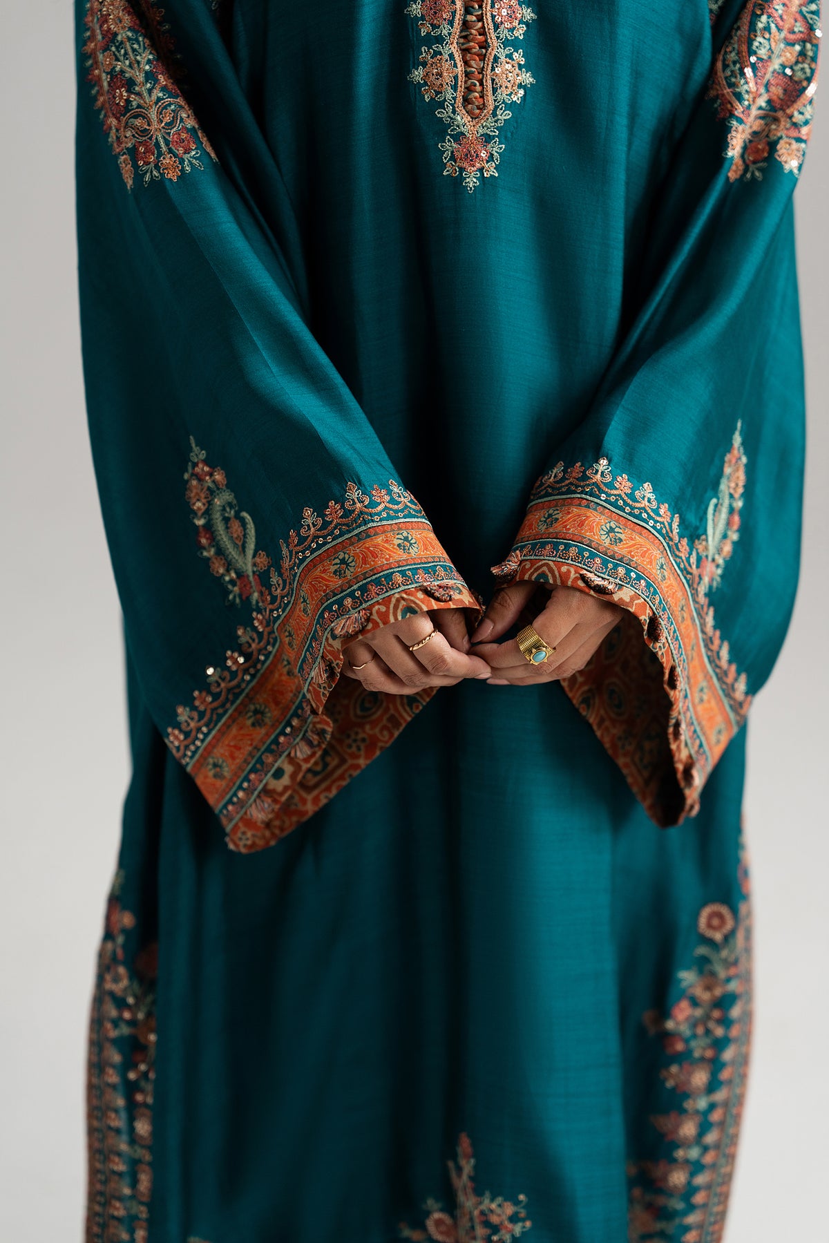 Teal blue Pakistani silk phiran with Kashmiri embroidery and tassel sleeve finishings — Afroz Set by Mannam