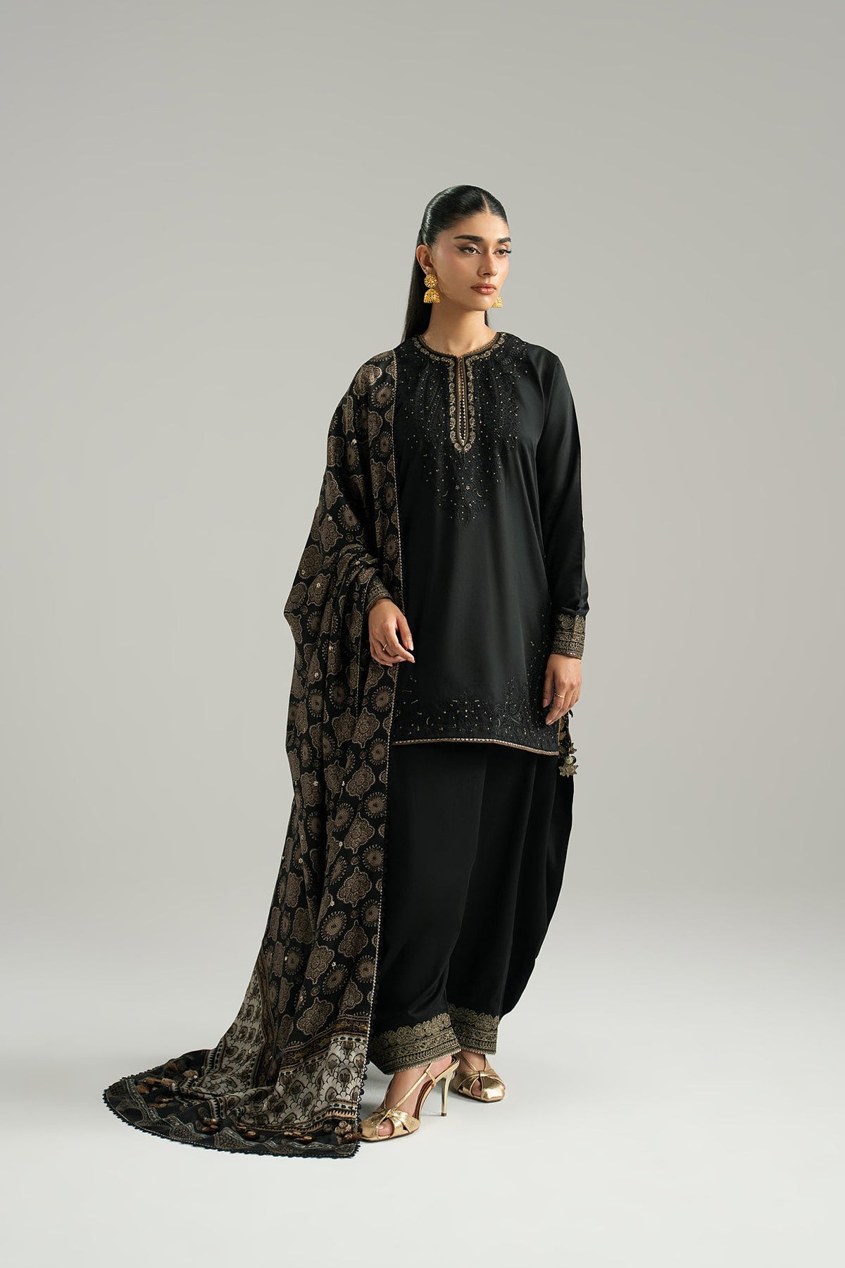 Black Pakistani kameez set worn — tilla embroidery on sleeves and side slits