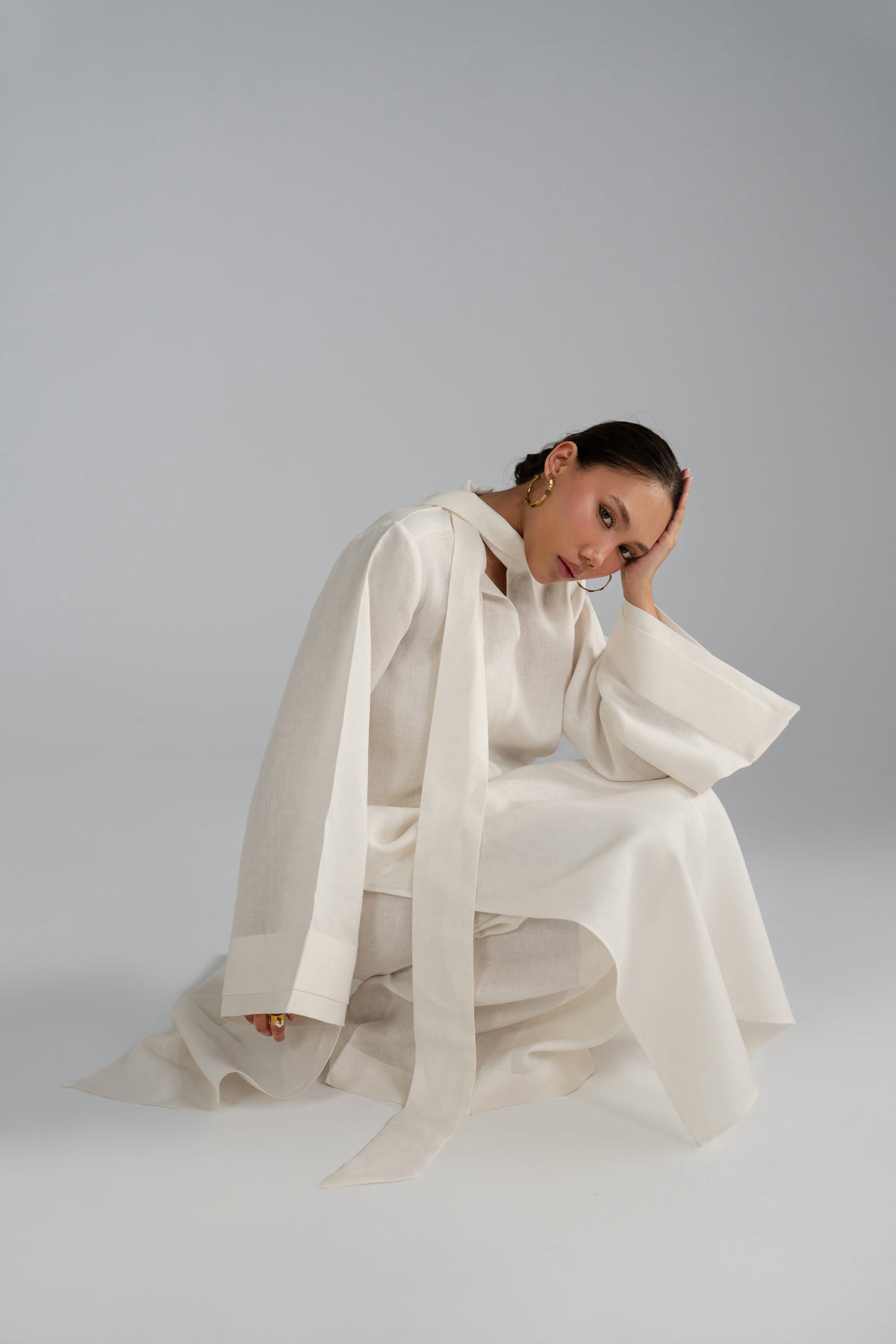 Seated pose in Mist Set co-ord, scarf drape detail