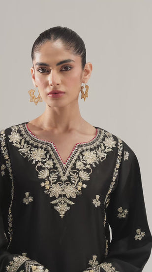 The bottom edge of the Starlight Set shirt featuring pink trim and fancy scalloped lace.
